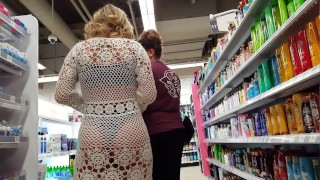 Candid voyeur blonde bikini girl in see through wrap shopping